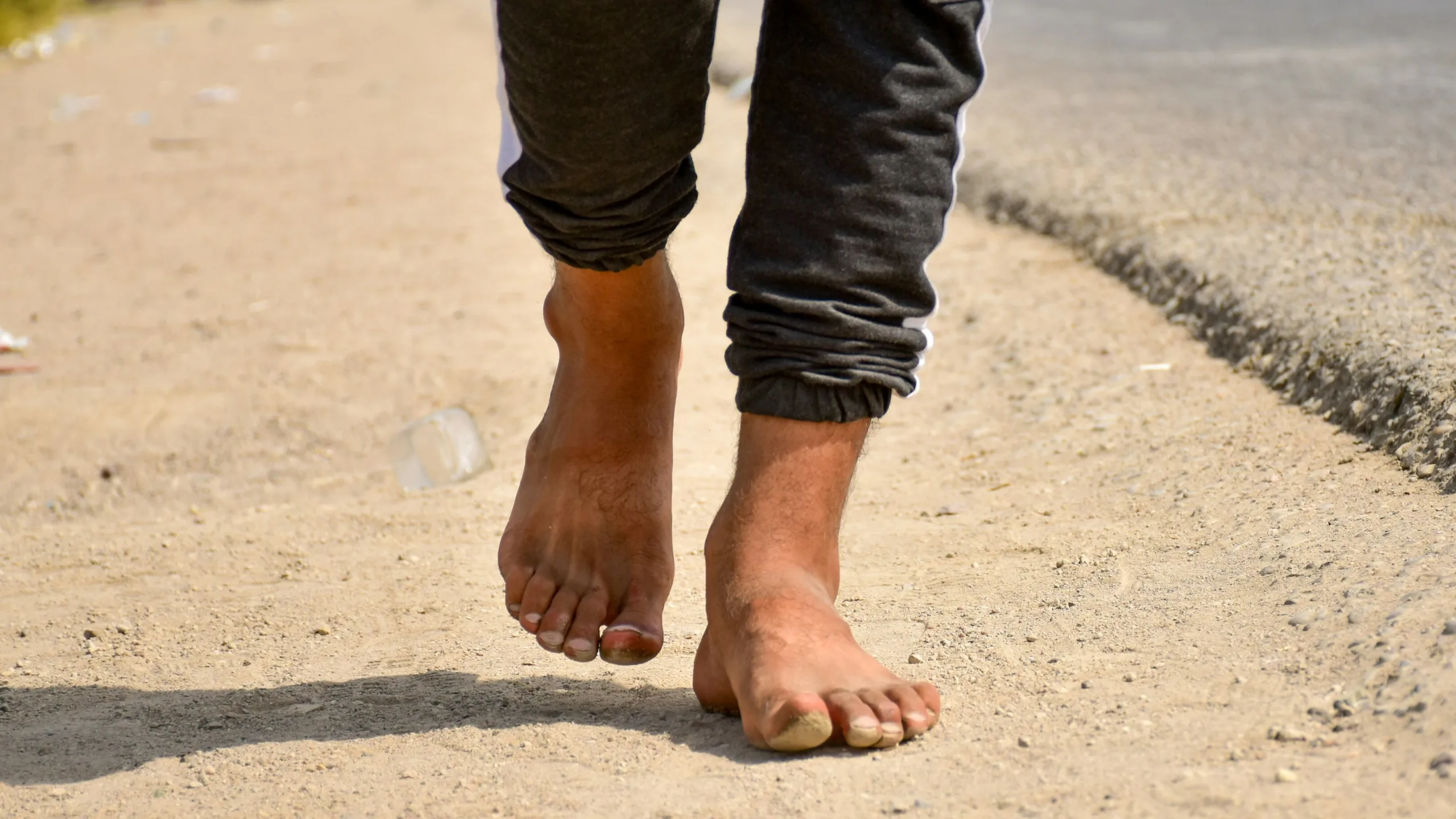 Personne marchant pieds nus sur un chemin de terre